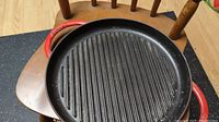 Top view of black ribbed cooking surface of the grill pan showing ridges designed for grilling.