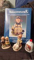 Cover photo of the Hummel Illustrated Handbook and Price Guide with four Hummel figurines displayed in front.