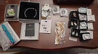 Overview photo showing assortment of jewellery: rings, earrings, bangle, and three beaded pens.