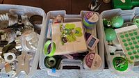 Plastic container with metal cookie cutters of various shapes and sizes