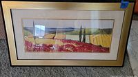 Full view of framed landscape artwork showing the entire piece lying on carpet.