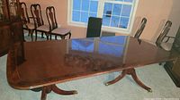 Table extended showing top and dual pedestals in room