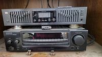Front view of Kenwood KR-A5060 receiver and BSR EQ-3000 equalizer stacked in a wooden shelf.
