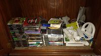 Overall shelf view with stacks of game cases, memory cards, adapter, console and accessories