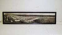 Framed panoramic aerial photograph showing rows of buildings in a military camp, identified as Camp Wheeler, GA in 1941.