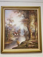 Full front view of the framed oil painting showing countryside landscape with river and trees.