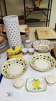 Full lot with various artisan pottery pieces and a ceramic lamp arranged on a table