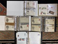 Full view of six binders and plastic sleeve pages containing vintage postage stamps, first day issue envelopes including US Presidents 1986, aviation pioneers, and foreign stamps, plus antique paper currency.