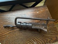 Side view of the antique Nepalese temple lock showing the full length and twisted handle.