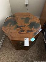 Top view of the octagonal wooden box showing lotus and bird painting and Korean calligraphy on the lid.