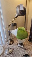 Vintage adjustable work lamp with gray metal head and gooseneck arm plus decorative table lamp with green glass shade and marble base