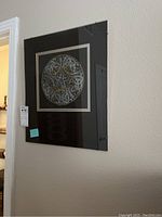 Framed Celtic knot grave rubbing hung on wall