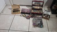 Full view of all jewelry components including boxes, plastic bag, bracelets, and watches.