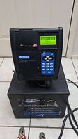 Full view of the diagnostic station on top of the charger base showing overall condition and setup.