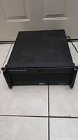 Front view of black Verint digital video recorder showing rackmount handles and air vents