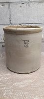 Front view of the larger stoneware crock showing the number 5 label and handle