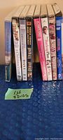 Eight DVD cases standing side by side showing spine titles and front covers of some titles.
