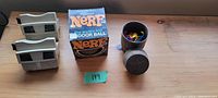 Two vintage plastic View-Masters, Official Nerf Ball box, and open Barrel of Monkeys container with colorful monkeys inside on wooden surface.