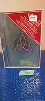 Front of DVD box set showing sealed packaging with triquetra symbol and series title
