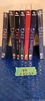 Photo showing all 7 DVD season sets standing upright with visible ABC Studios branding on top and Once Upon a Time series title on spine, unopened in original shrink wrap.