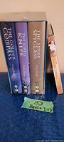 Box set of three hardcover books (The Golden Compass, The Subtle Knife, The Amber Spyglass) in slipcase showing titles and author Pullman