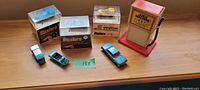 View of all seven pieces showing three Hot Wheels Sizzlers cars in original cases, four additional cars, and the Juice Machine recharging station toy.