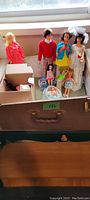 Top wide shot of all the dolls standing and lying in the storage box, showing the condition and variety of the dolls