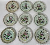 Nine smaller floral patterned plates arranged in three rows of three.