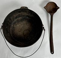 Overhead shot showing both kettle bowl and ladle side by side on a white background.