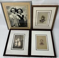 Four framed antique photographs placed side by side showing variety and framing styles.