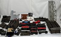 Full overview showing large assortment of Lionel and Marx O-Gauge trains, track pieces, bridge, and control modules