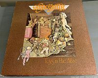 Photo of Aerosmith Toys in the Attic 12-inch vinyl album cover with detailed illustrated artwork