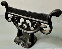 Front angled view of the Victorian cast iron boot scraper showing decorative scrollwork and black lacquer finish.