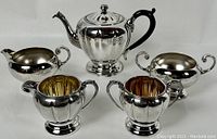 Full view of the Marlboro silver plate tea set including teapot, creamer, sugar bowl, and two matching jugs on a white background