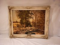 Full front view of the framed artwork showing the winter landscape and ornate frame.