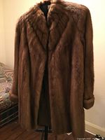 Full front view of the brown fur jacket showing length and overall appearance