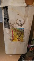 Photo of original box showing water damage and product label
