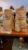 Pair of carved Mexican marble bookends in pinkish color showing the front and side views.