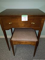 Singer sewing machine cabinet with closed wooden top and stool underneath