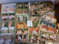Top-down photo showing all 25 stereoview cards arranged in rows. Cards feature children in various outdoor and indoor settings, dressed in early 1900s attire.