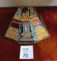 Top view of the pyramid-shaped jewelry box showcasing glass mosaic tile artwork with a central blue scarab beetle motif.