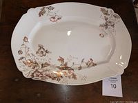 Top view of the large oval platter showing the Autumn Tint floral and leaf pattern on white ceramic with scalloped edges.