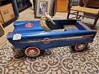 Right side view showing STP decal, racing stripe, badge and red wheels