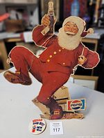 Front view of Santa stand display holding bottle and pinback button shown at base