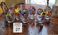Front view of all six glasses showing colorful Mickey Mouse 60th anniversary designs with respective years