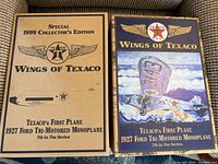 Two boxed collector's edition sets for Texaco's 1927 Ford Tri-Motored Monoplane, labeled as 7th in the Wings of Texaco series, one with artistic aircraft scene and the other technical schematic on the box.