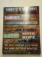 Inspirational word art vinyl print on multicolored wooden plank background with phrases encouraging kindness, compassion, justice, and hope.