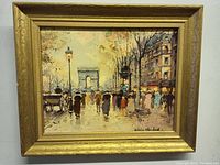 Front view of framed print depicting Paris street scene with Arc de Triomphe and pedestrians, signed Antoine Blanchard.
