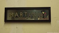 Front view of one bar wall art piece with the word 'MARTINI' and a Martini glass graphic in a black frame.