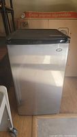 Front view of the stainless steel mini refrigerator showing overall condition and design.